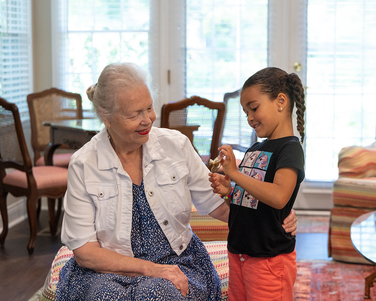 Memory care resident at Westminster Place spending time with her young granddaughter