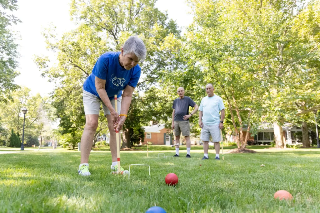 seniors at Westminster Place playing croquet in the shade to follow summer safety tips for seniors 